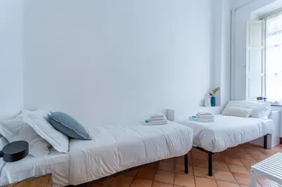 a white room with a bed and a couch at Iflat Comfortable & Spacious Dolce Vita Retreat in Rome