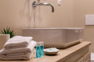 a bathroom with a sink and towels on a counter at Iflat Comfortable & Spacious Dolce Vita Retreat in Rome