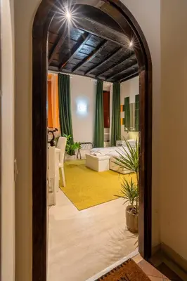 a living room with a mirror and a living room with a couch at Luxury Trevi in Rome