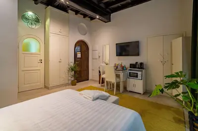 a bedroom with a bed and a table and a kitchen at Luxury Trevi in Rome