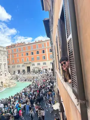 a large crowd of people looking out of a window at Luxury Trevi in Rome