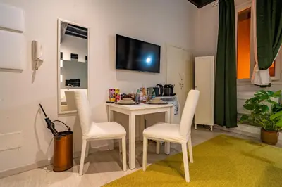 a living room with a table and chairs and a television at Luxury Trevi in Rome