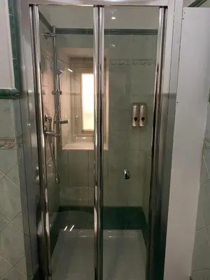 a shower with a glass door in a bathroom at Domus Porta Furba in Rome