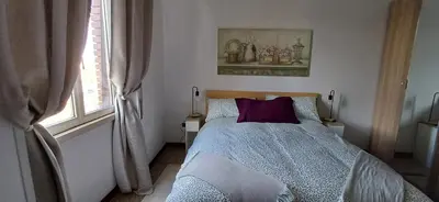 a bedroom with a bed with a purple pillow at Casetta clodio in Rome