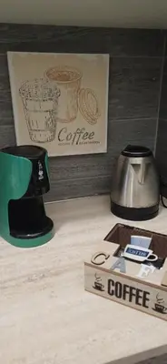 a table with a coffee cup and a coffee pot at Casetta clodio in Rome
