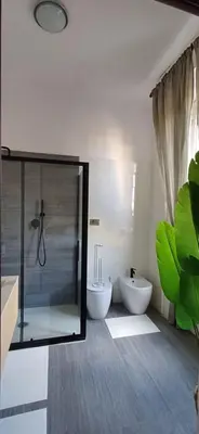 a bathroom with a glass shower and a toilet at Casetta clodio in Rome
