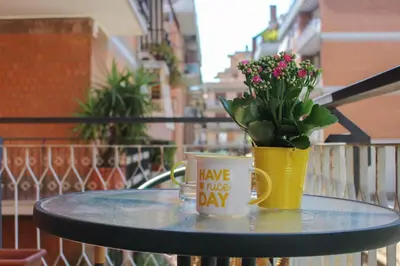 two coffee mugs sitting on a table with a potted plant at Domus Casaletto in Rome