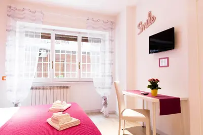 a dining room with a red table and a window at Domus Casaletto in Rome