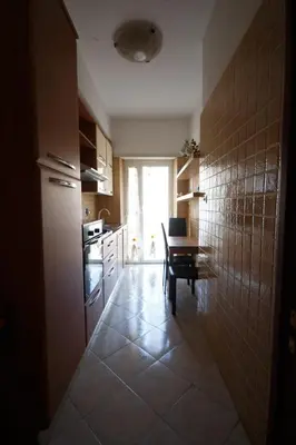 a kitchen with a table and a dining room at Er Pirata in Rome