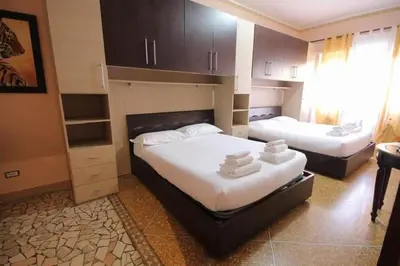 a bedroom with two beds in a room with a window at Er Pirata in Rome