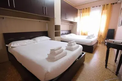 two beds in a hotel room with towels on them at Er Pirata in Rome