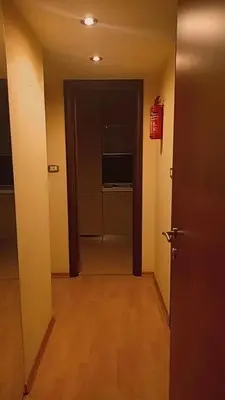 a hallway with a door and a room with a fire extinguisher at Casa Gemelli Gemelli in Rome