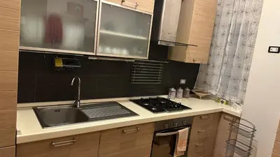 a kitchen with a sink and a stove at Casa Gemelli Gemelli in Rome