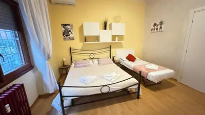 a small room with two beds and a window at Casa Gemelli Gemelli in Rome
