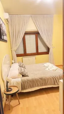 a bedroom with a bed with a window and a table at Casa Gemelli Gemelli in Rome