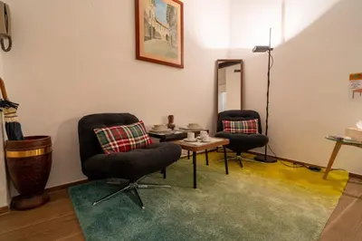 a room with two chairs and a table and a mirror at The Luxury Roma Amor in Rome