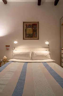 a bed with two lights on top of it at The Luxury Roma Amor in Rome