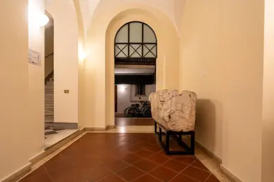 a chair in the hallway of a house at The Luxury Roma Amor in Rome