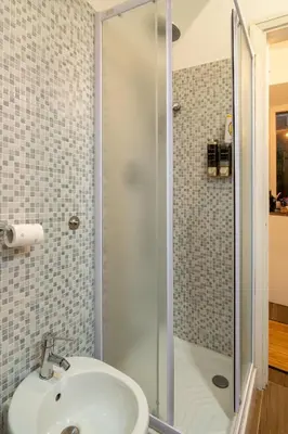 a bathroom with a sink and a shower at The Luxury Roma Amor in Rome