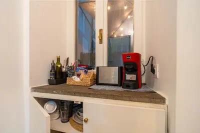 a kitchen with a counter with a red coffee machine at The Luxury Roma Amor in Rome
