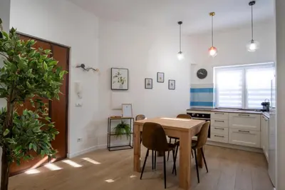 a kitchen with a table and chairs in a room at Elegantis Santa Croce Suite Apartment in Rome