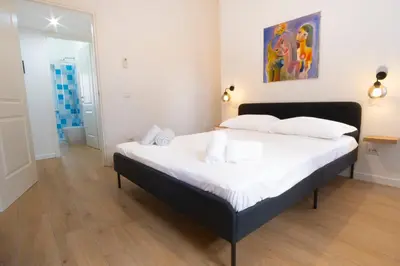 a bedroom with a large bed with white sheets at Elegantis Santa Croce Suite Apartment in Rome