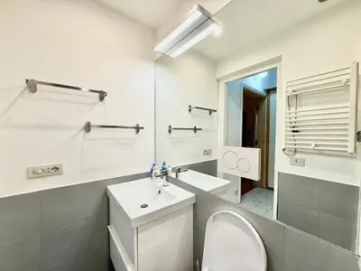 a bathroom with a sink and a toilet and a mirror at Two Bedrooms Spanish Steps Apartment in Rome