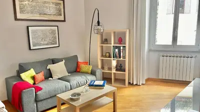 a living room with a couch and a coffee table at Two Bedrooms Spanish Steps Apartment in Rome