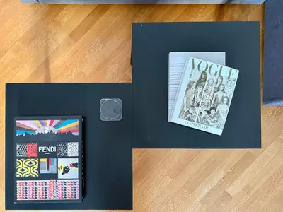 two books on a table next to a picture of a book at Two Bedrooms Spanish Steps Apartment in Rome