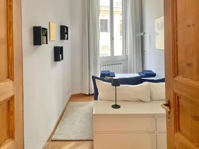 a room with two beds and a window at Two Bedrooms Spanish Steps Apartment in Rome