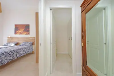 a bedroom with two beds and a door to a hallway at Balconcino romantico a via Aosta in Rome