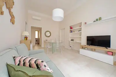 a living room with a couch and a tv at Balconcino romantico a via Aosta in Rome