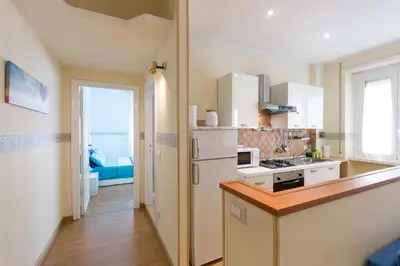a kitchen with a white refrigerator and a stove at Casa Vacanze La Bomboniera in Rome