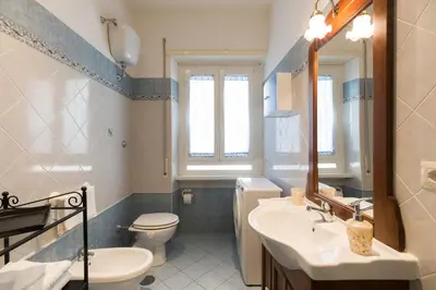 a bathroom with a sink and a toilet and a mirror at Casa Vacanze La Bomboniera in Rome