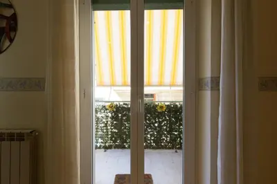 a sliding glass door with a view of a yard at Casa Vacanze La Bomboniera in Rome
