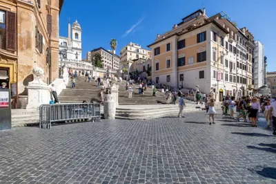 a group of people walking down a street with stairs at Suite Spagna - Terrazza su Piazza di Spagna in Rome