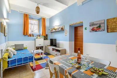 a bedroom with a bed and a dining room with a table at Children House Apartment in Rome