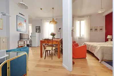 a living room with a table and a bedroom at Olimpia in Rome