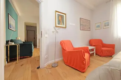 a living room with two orange chairs and a bed at Olimpia in Rome