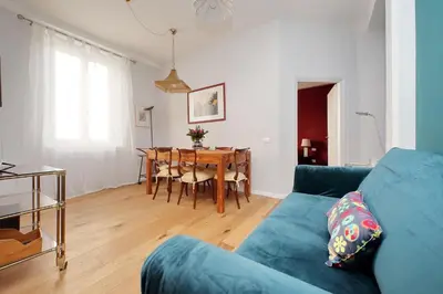 a living room with a blue couch and a table at Olimpia in Rome