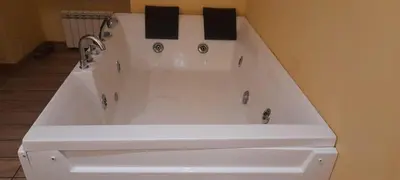 a white bath tub with a faucet in a bathroom at Kotel rome residenza piazza bologna in Rome