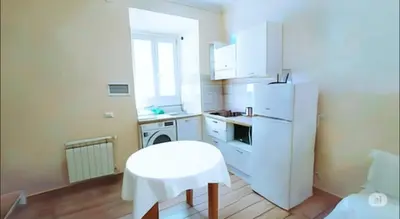 a kitchen with a white refrigerator and a white stool at Kotel rome residenza piazza bologna in Rome