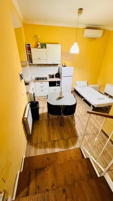 a living room with a table and a kitchen at Kotel rome residenza piazza bologna in Rome