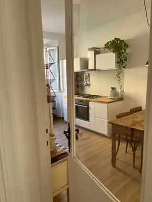 a kitchen with a table and a dining room at La Spezia 28 Royal in Rome