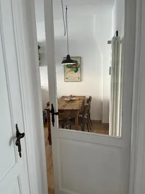 a door leading into a dining room with a table at La Spezia 28 Royal in Rome