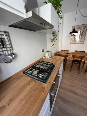 a kitchen with a stove and a wooden counter top at La Spezia 28 Royal in Rome