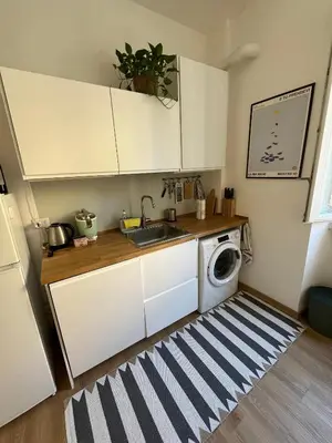 a kitchen with a sink and a washing machine at La Spezia 28 Royal in Rome