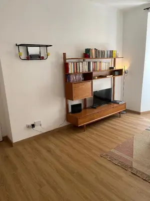 a living room with a book shelf with books at La Spezia 28 Royal in Rome