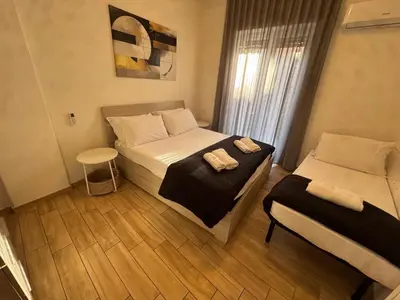 a bedroom with two beds with towels on them at Luciano Colosseo Apartment in Rome