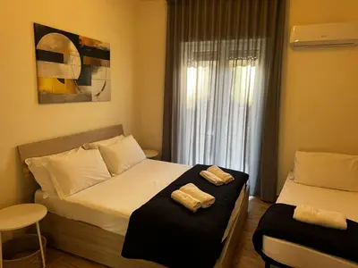a bedroom with two beds with towels on them at Luciano Colosseo Apartment in Rome